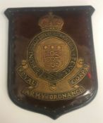 An early 20th Century plaque with leather embossed decoration inscribed "Royal Army Ordnance Corps