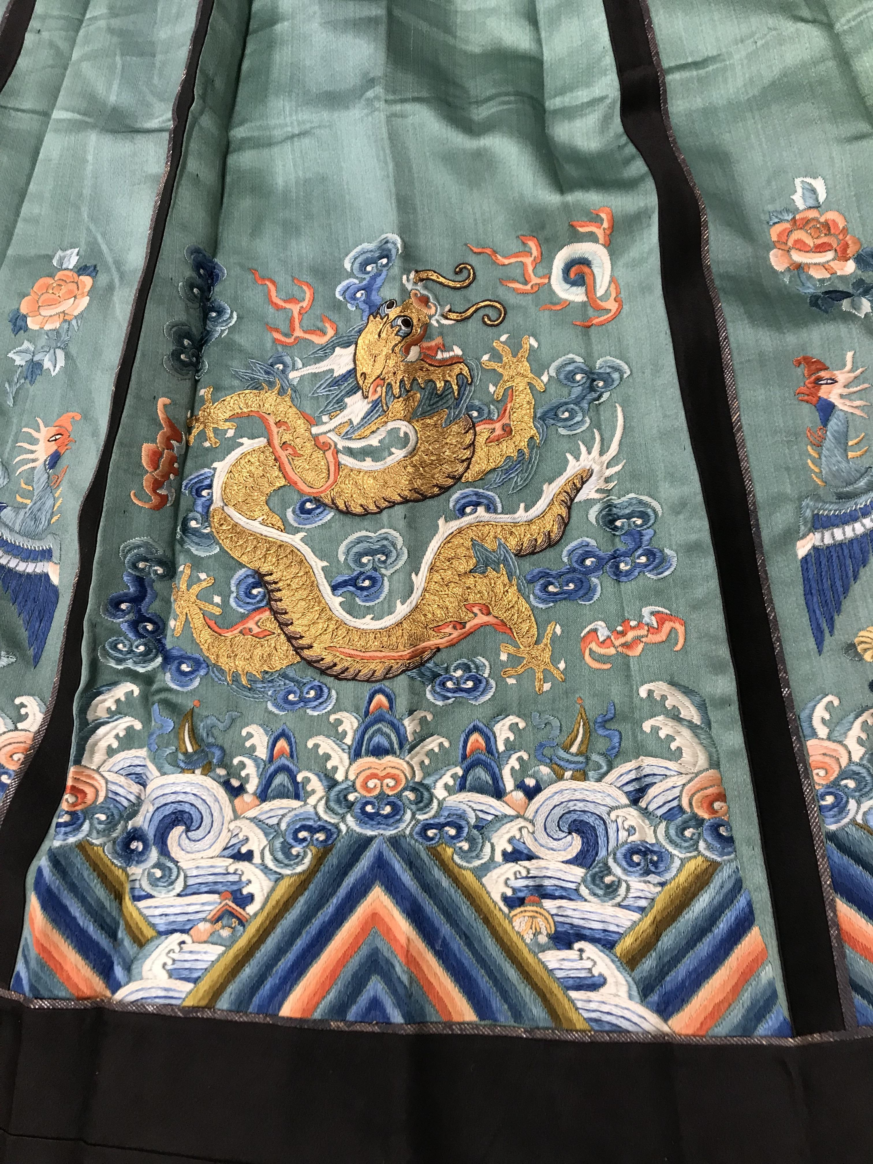 A Chinese teal silk skirt with black borders and a peach waistband, silk panels embroidered in blue, - Image 41 of 69