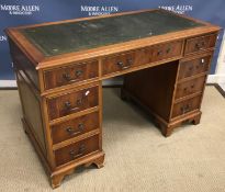 A reproduction mahogany kneehole desk,