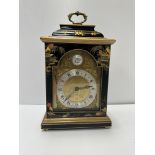 A modern black lacquered and chinoiserie decorated mantel clock in the 18th Century manner,