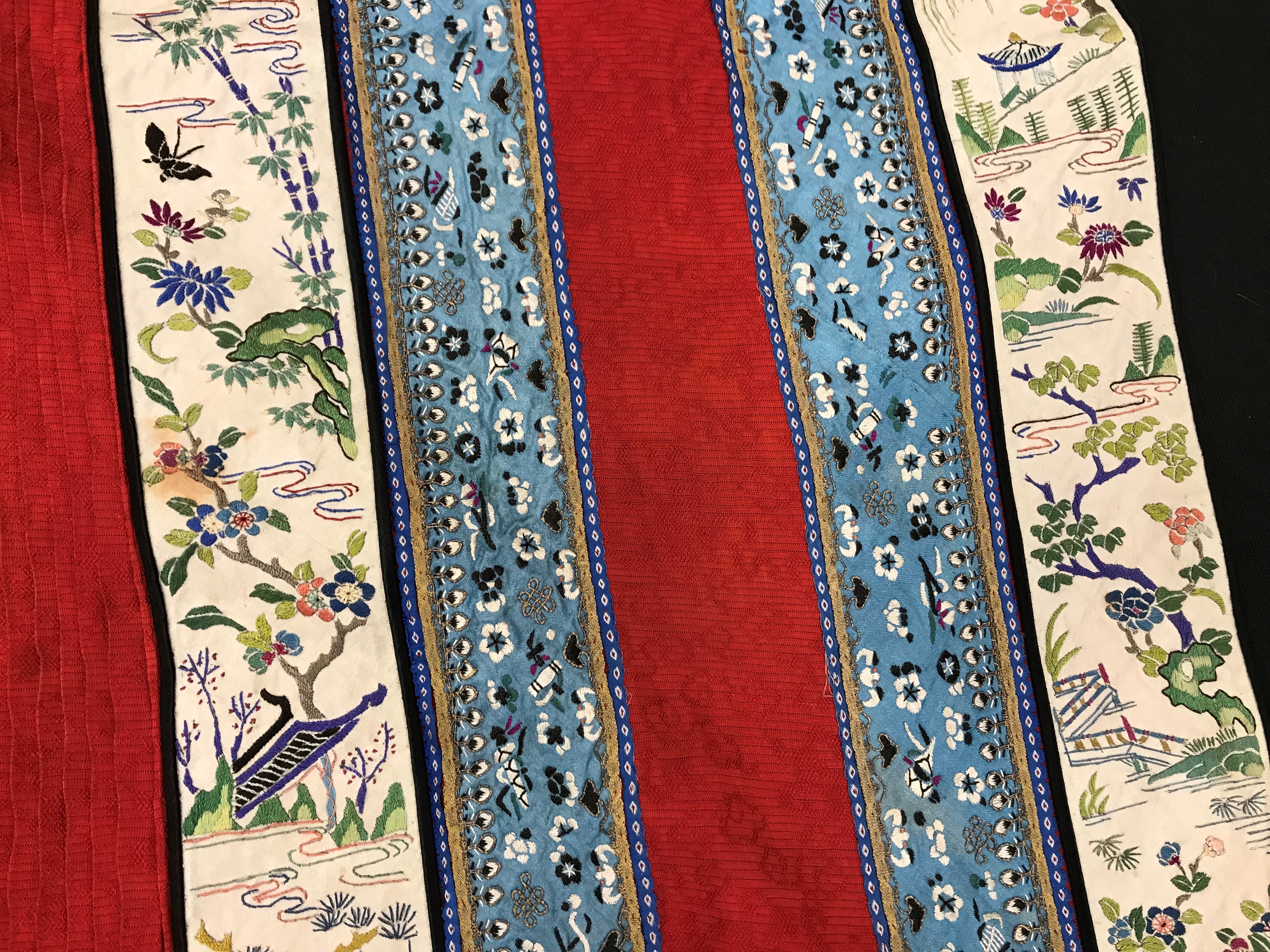 A Chinese red finely pleated silk skirt with blue and cream overlaid silk bands heavily embroidered - Image 27 of 31