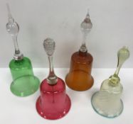 A collection of seven coloured glass table bells,