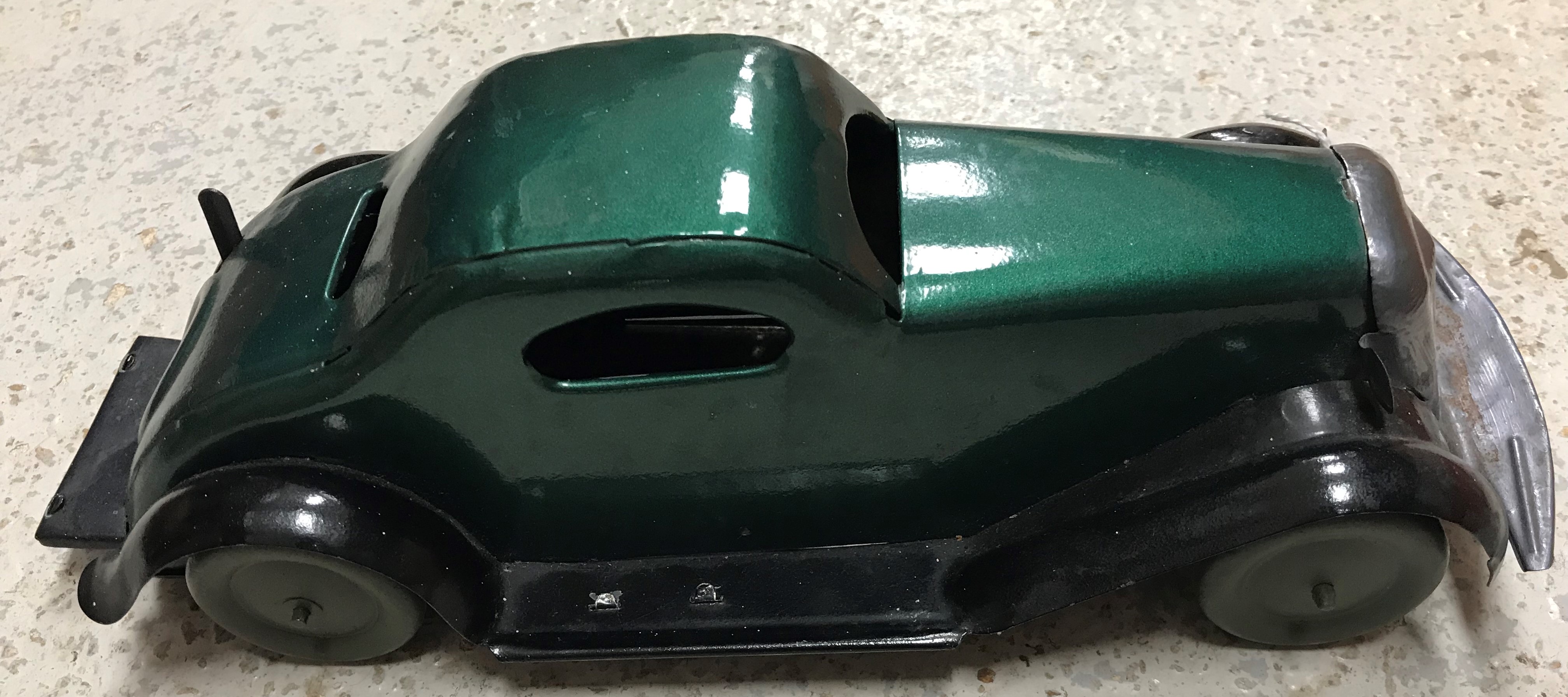 A painted tin clockwork car after a circa 1935 design by Louis Marx bearing stamp to underside - Image 2 of 2