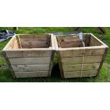 A pair of slatted wooden tapered square planters,