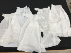 Four boxes including a number of christening gowns, tablecloths,