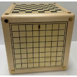 An Alison Henry game cube, each side printed with various games boards including backgammon, chess,