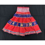 A Rajhistani skirt in red and blue stripes with overlaid embroidery and mirrored decorations,