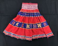 A Rajhistani skirt in red and blue stripes with overlaid embroidery and mirrored decorations,