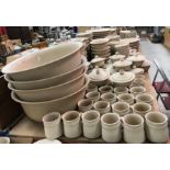 A large collection of oatmeal glazed pottery dinner wares bearing potter's mark impressed "R"