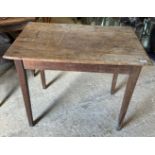 A Victorian pine kitchen table, the plank top above a plain frieze on square tapered legs, 88.