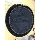 Four black damask circular tablecloths with black and gold braid and fringing,