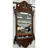 A walnut framed fretwork carved wall mirror in the early 18th Century manner with Prince of Wales