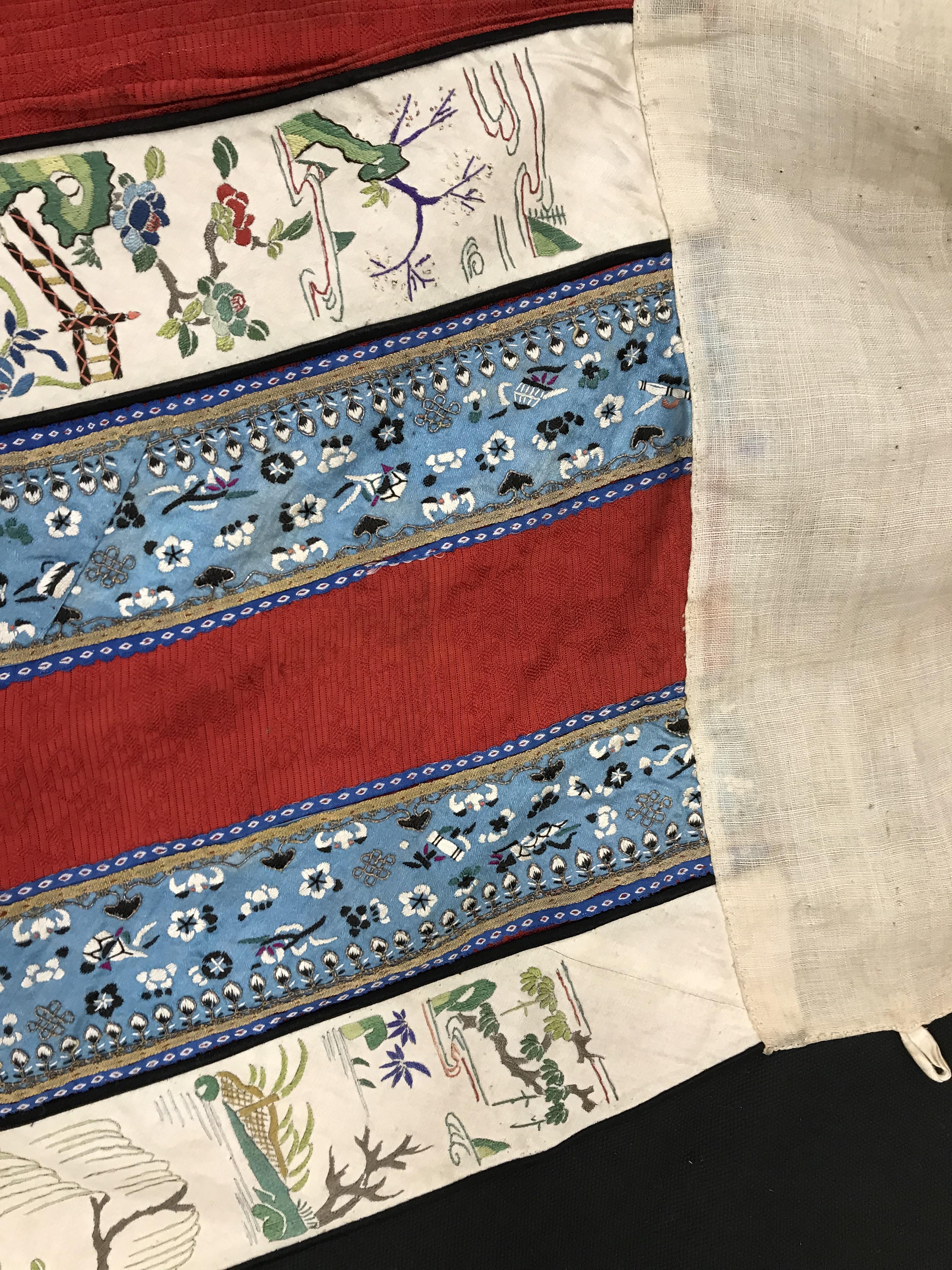 A Chinese red finely pleated silk skirt with blue and cream overlaid silk bands heavily embroidered - Image 29 of 31