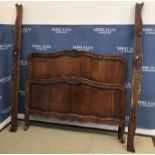 A 20th Century French walnut bedstead in the Louis XV provincial manner,