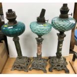 Three various Art Nouveau style oil lamps with turquoise glass reservoirs on marble columns to