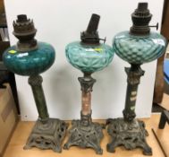 Three various Art Nouveau style oil lamps with turquoise glass reservoirs on marble columns to