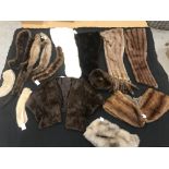 Two boxes containing a collection of various fur tippets and stoles