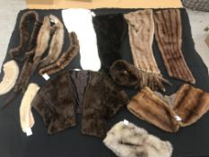 Two boxes containing a collection of various fur tippets and stoles