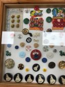 A frame containing a display of coloured buttons, size ranging from approx 5-20 mm diameter,