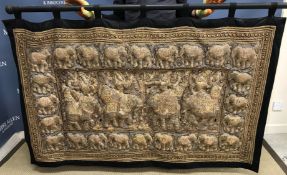 A Thai tapestry with black borders and design of elephants embroidered in various colours of gilt
