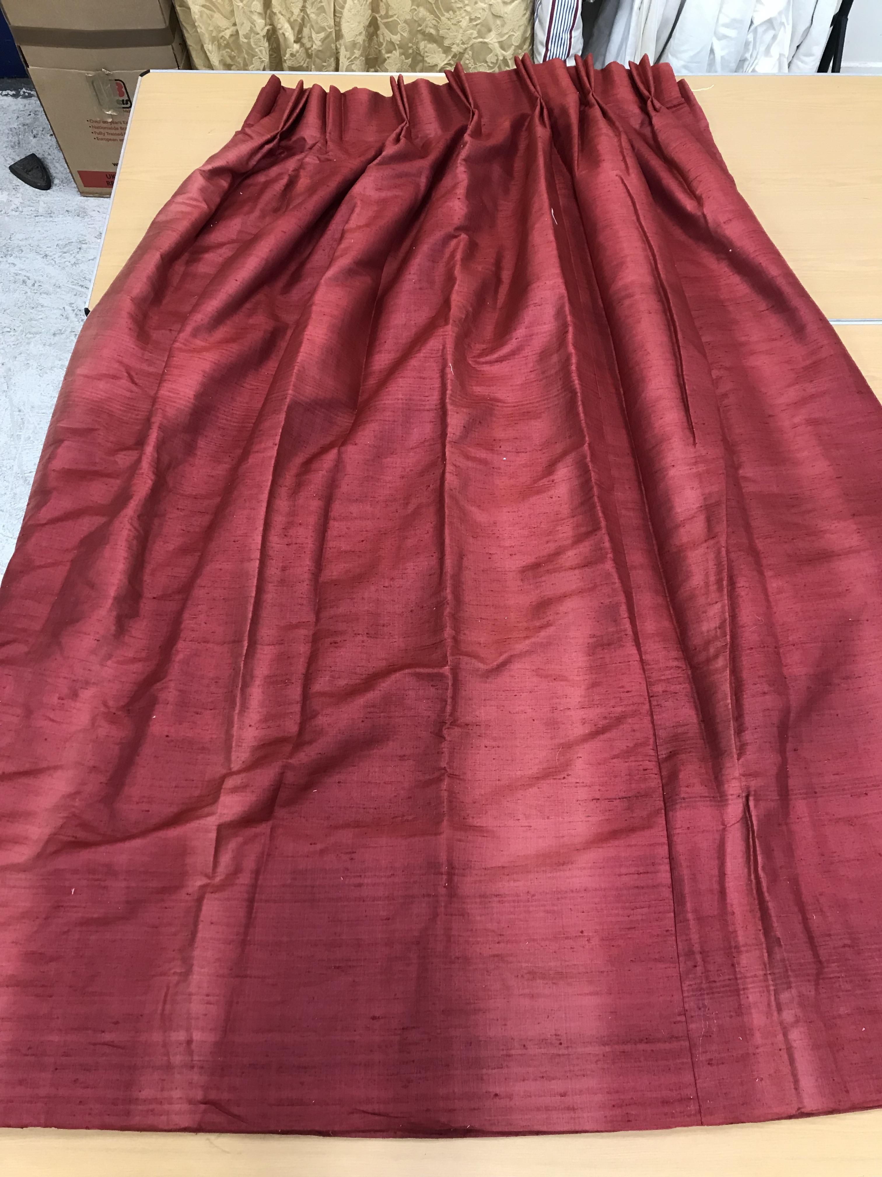 One pair of burgundy silk interlined curtains with double pencil pleat fixed headings,
