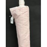 A part roll of pink and white gingham patterned heavyweight cotton,