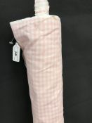 A part roll of pink and white gingham patterned heavyweight cotton,