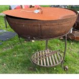 A cast iron and studded fire pit with cover and stand,