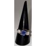 A platinum mounted ladies dress ring with central oval cut pale blue sapphire, approx 1 carat,