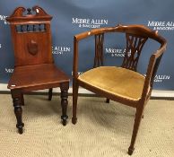 A late Victorian mahogany panel seated hall chair and an Edwardian yoke back elbow chair on square