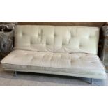 A modern cream upholstered banquette of plain buttoned form,