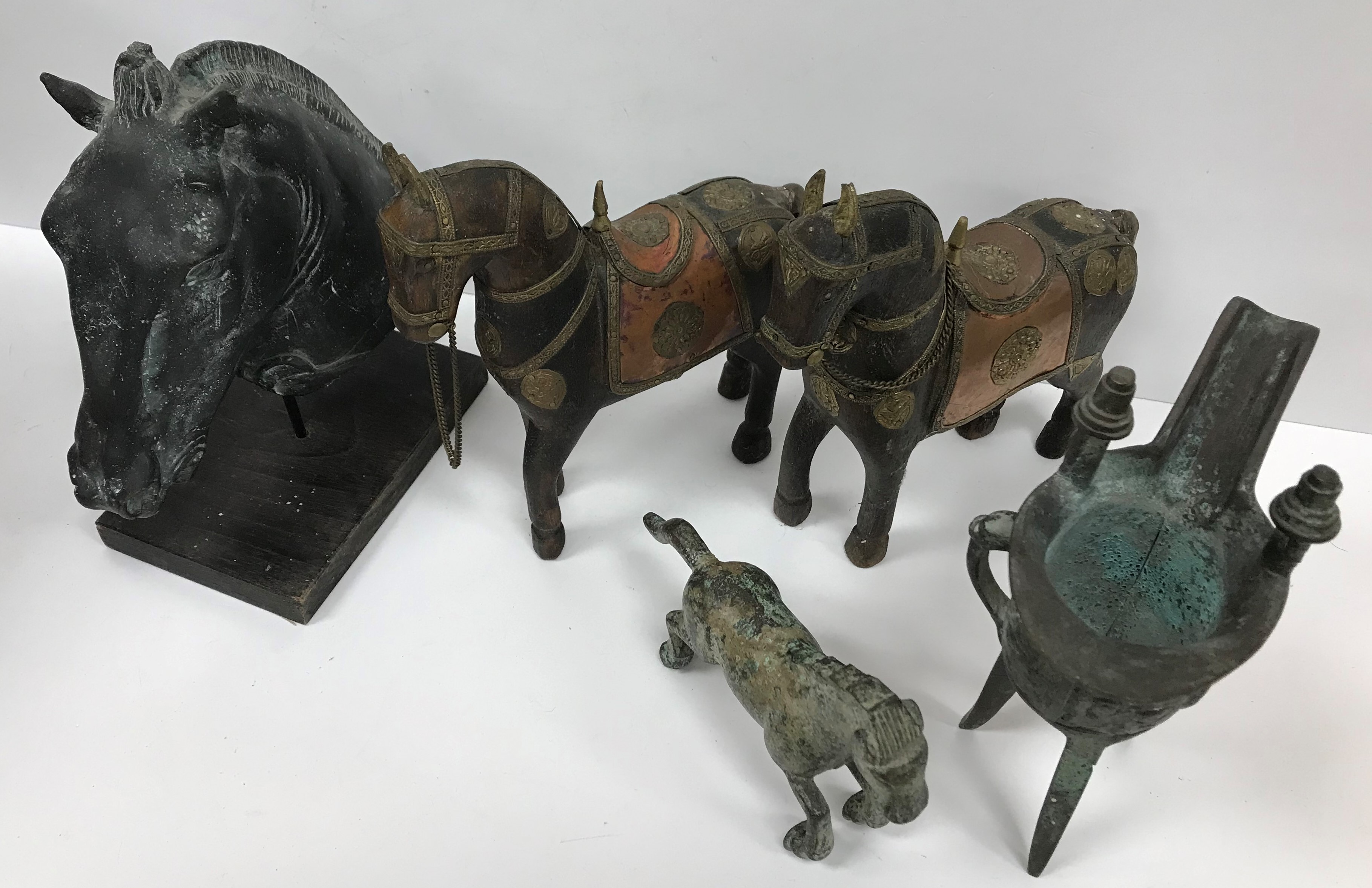 A collection of various Oriental wares to include a modern bronze oil lamp of helmet form in the