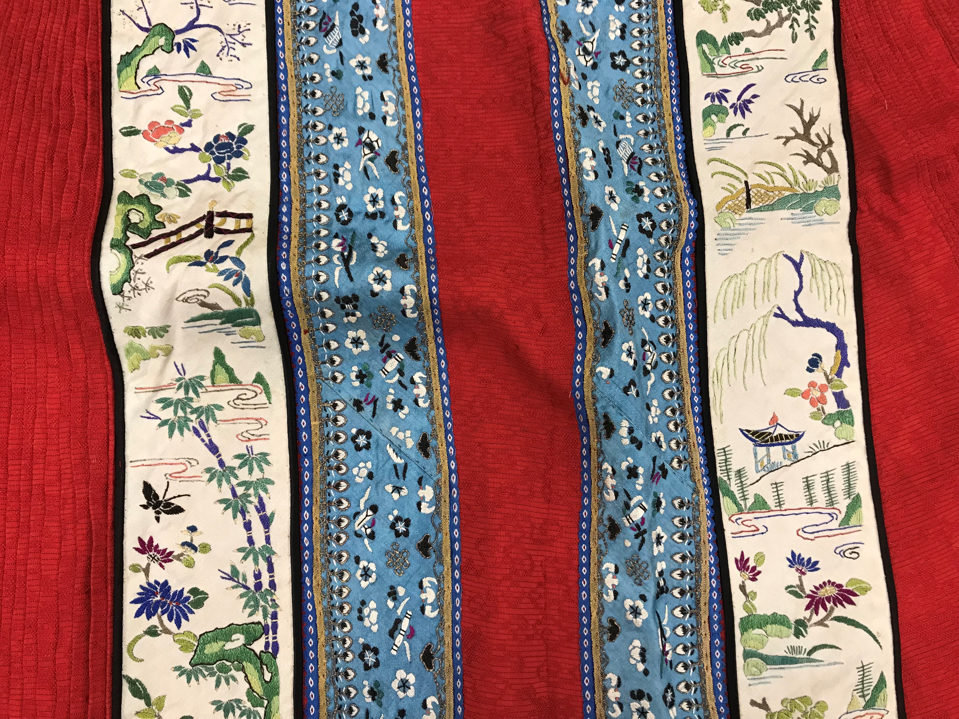 A Chinese red finely pleated silk skirt with blue and cream overlaid silk bands heavily embroidered - Image 16 of 31