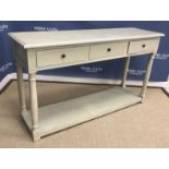A modern painted side table with turned knob handles,