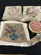 A box containing two tapestry cushions with floral design and fringing,