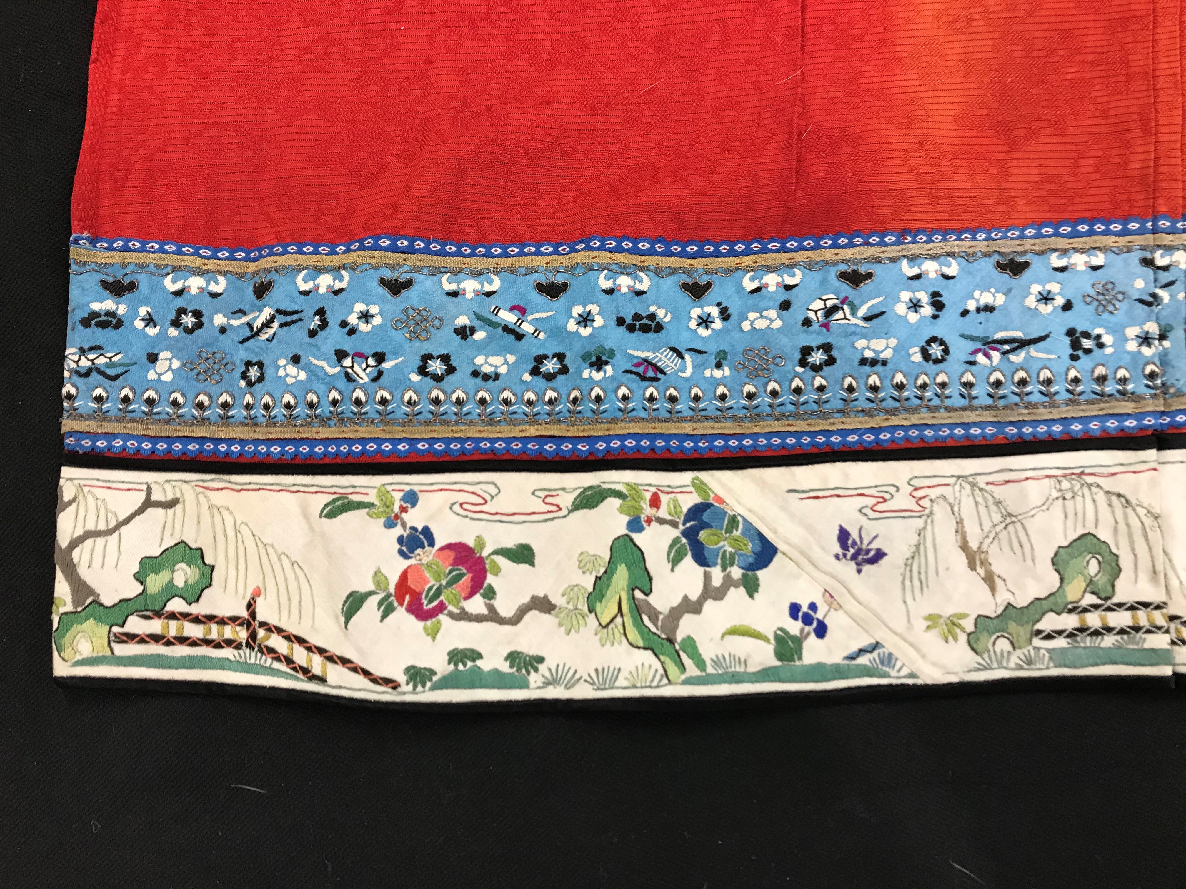A Chinese red finely pleated silk skirt with blue and cream overlaid silk bands heavily embroidered - Image 11 of 31