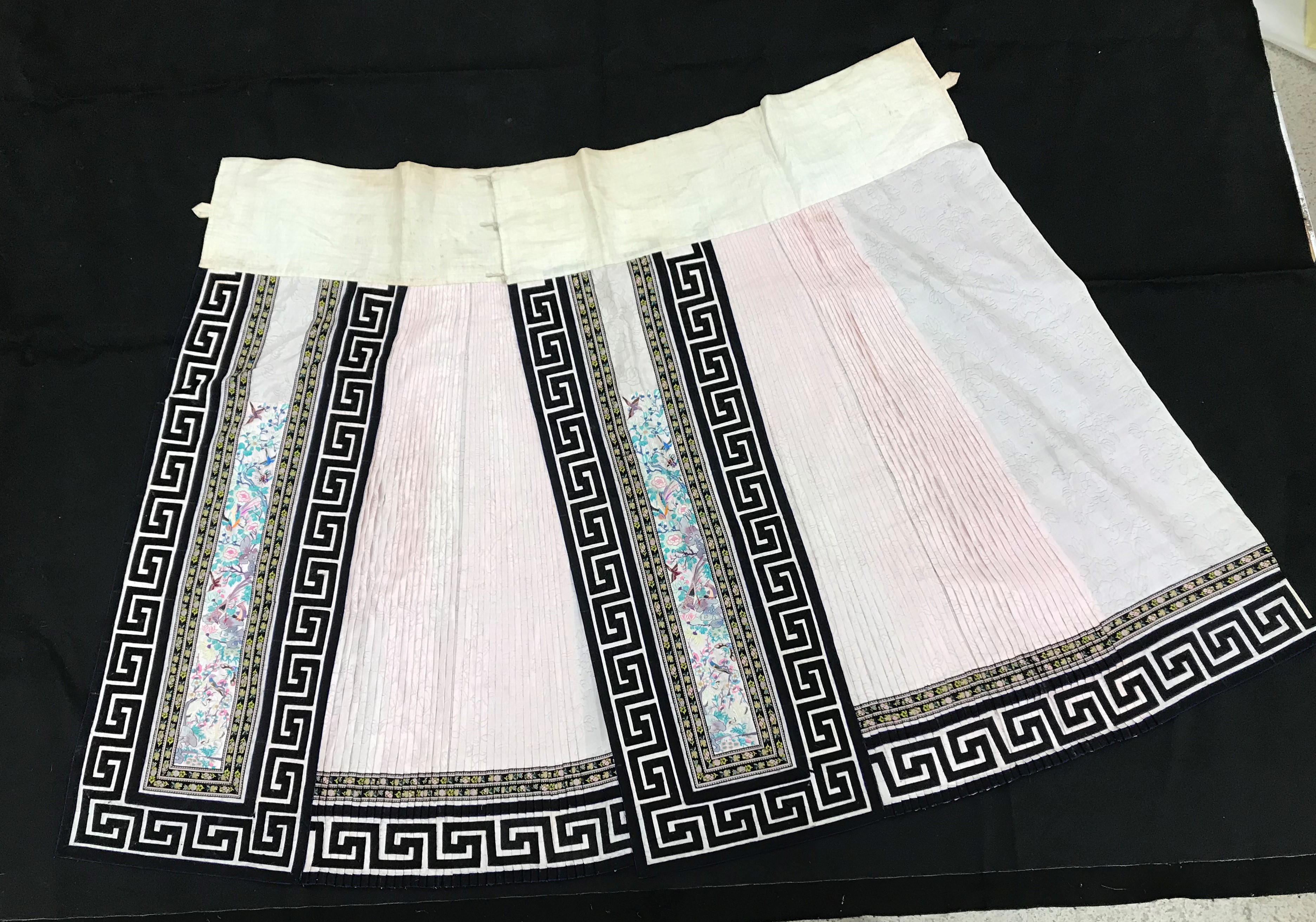 A Chinese silk skirt in two panels with a pink background overlaid with borders of Greek key type - Image 2 of 21