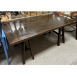A modern mahogany trestle dining table, the plain rectangular top on A frame trestle supports,
