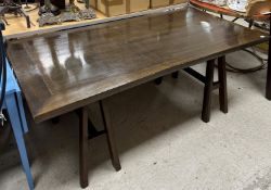 A modern mahogany trestle dining table, the plain rectangular top on A frame trestle supports,