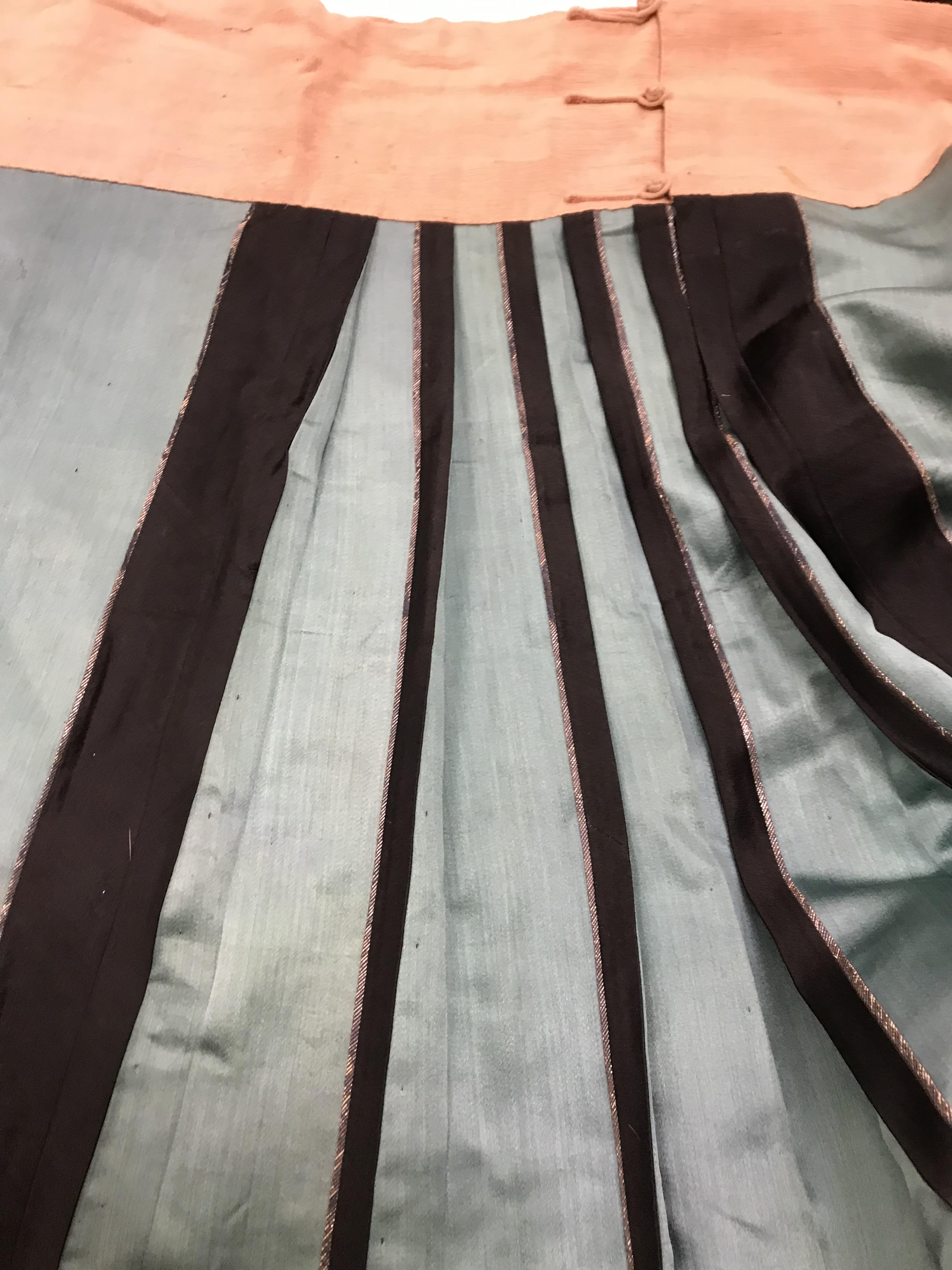 A Chinese teal silk skirt with black borders and a peach waistband, silk panels embroidered in blue, - Image 27 of 69