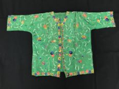A Chinese green silk top with chain stitched foliate embroidery to the main body,