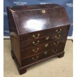 A George III figured mahogany bureau, the plain top over a twin-panelled figured front,