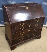 A George III figured mahogany bureau, the plain top over a twin-panelled figured front,