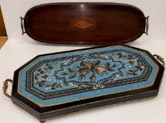 A Victorian ebonised and beadwork decorated elongated octagonal tray or stand with ornate brass