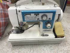 A "Dressmaker" electric sewing machine in case,