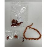 A carnelian bead necklace, 46 cm long, another carnelian bead necklace in need of re-stringing,