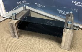 A modern glass topped coffee table on a simulated black walnut decorated end support with chrome