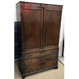 A 19th Century mahogany linen press with two cupboard doors enclosing a hanging space over three