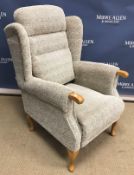 A modern upholstered wing back scroll arm chair on stained beech cabriole legs,