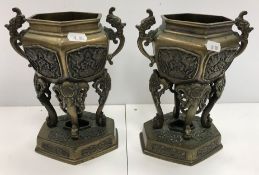 A pair of Chinese bronze urns or censers of hexagonal form with relief work decoration of exotic